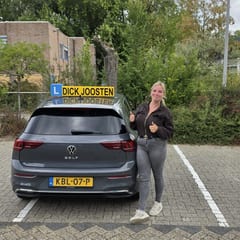 Lizzy bij de VW Golf-lesauto na haar examen